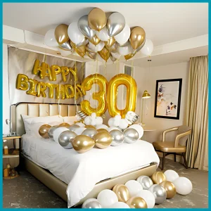 Golden and silver room decor setup in Dubai with helium balloons, foil age numbers, and happy birthday wall balloon